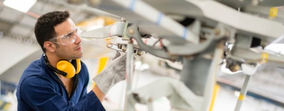 A person working on an airplane in the air.